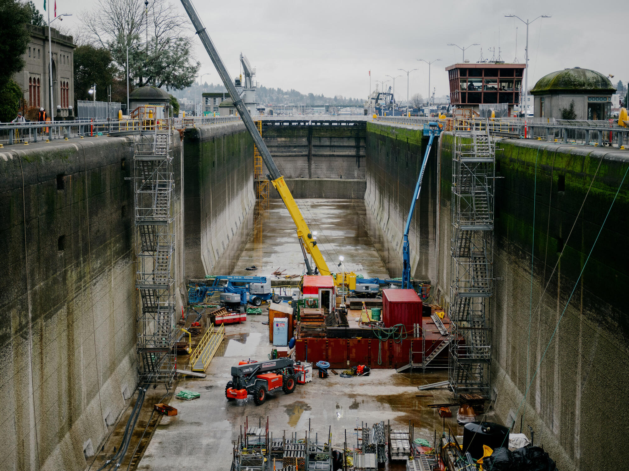 Construction equipment in a large outdoor concrete chamber.