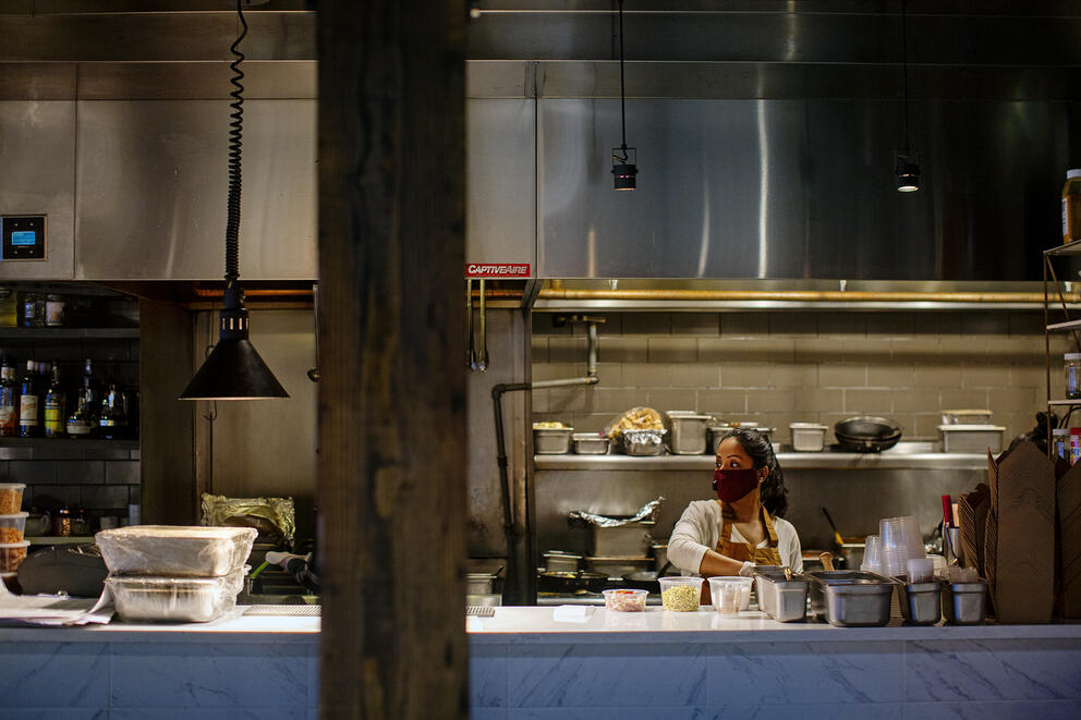 woman with mask in large open kitchen