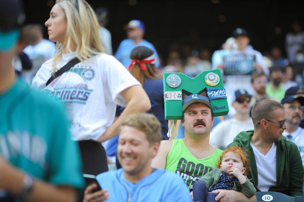 Fans sit in the stands at a baseball stadium