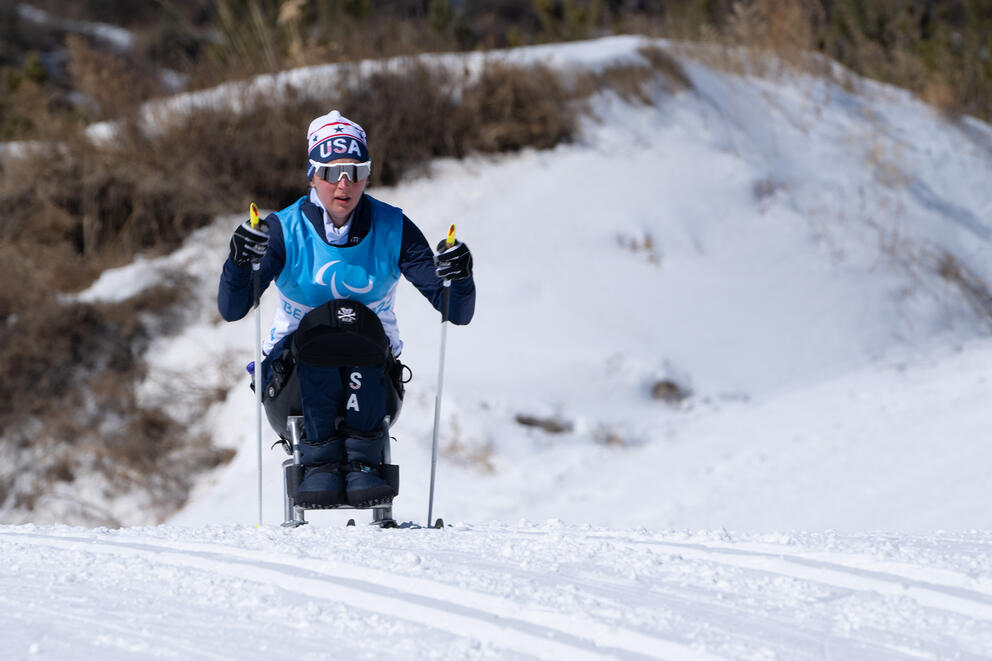 Seattle Nordic paraskier Erin Martin wearing blue and a team USA hat as she trains on snow