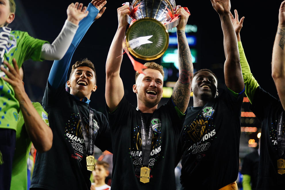 Victorious athletes holding up a trophy