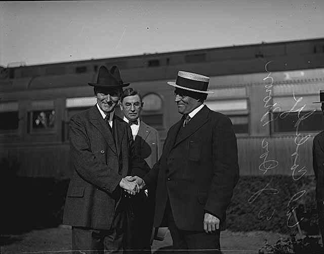 Two men in hats shaking hands