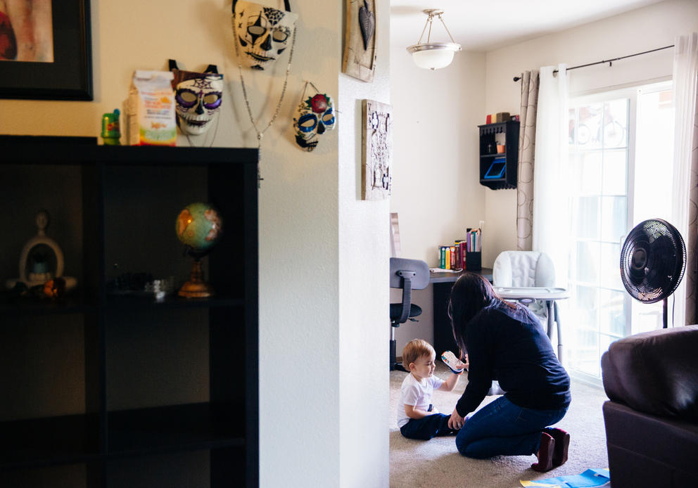 Jen Justice helps her toddler with his shoes
