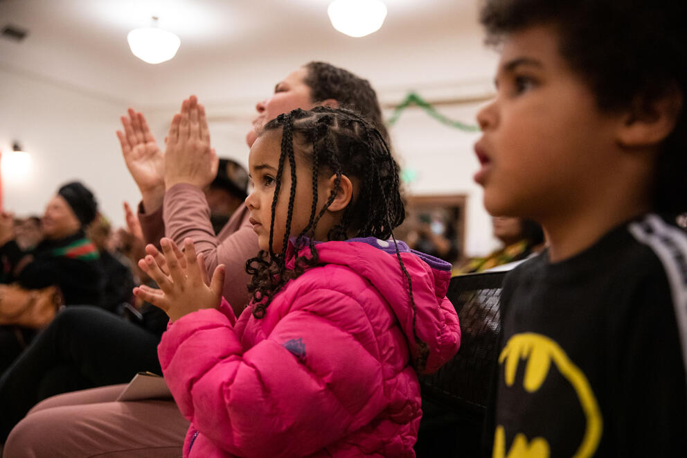 A close up of two children applauding