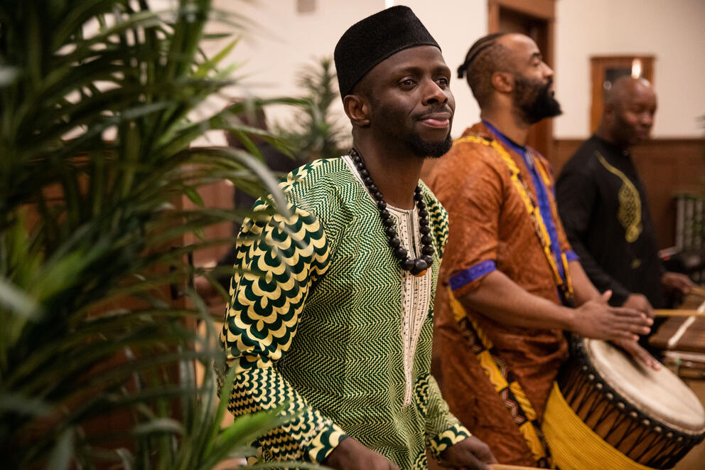 Men in traditional dress play the drums