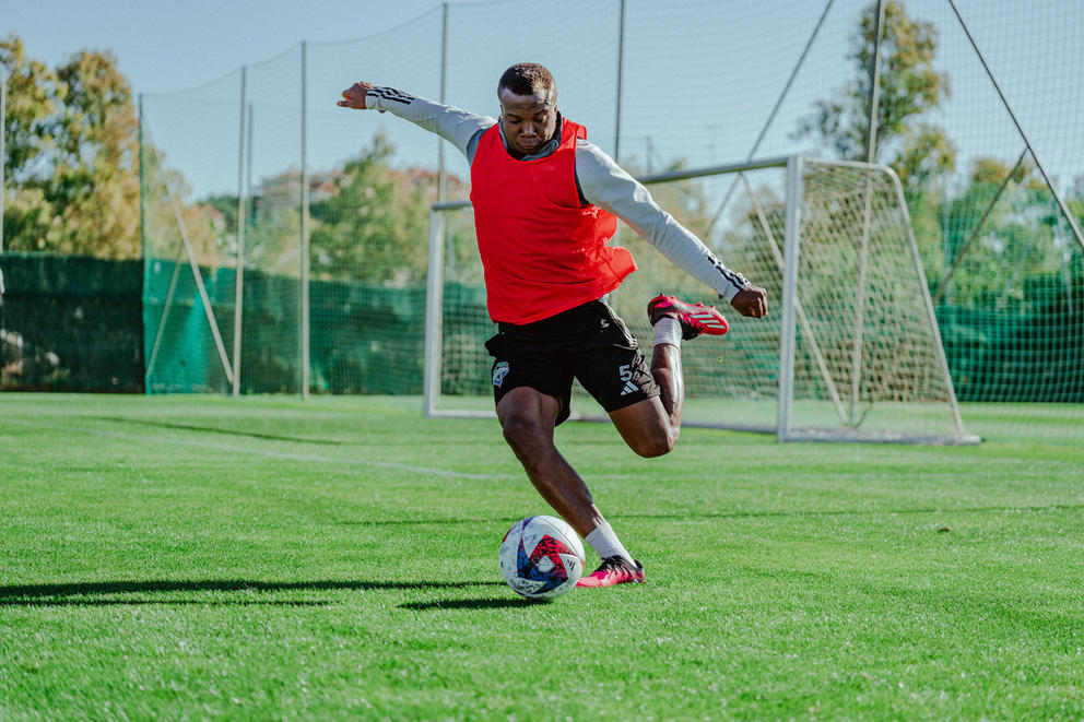 A man kicking a soccerball