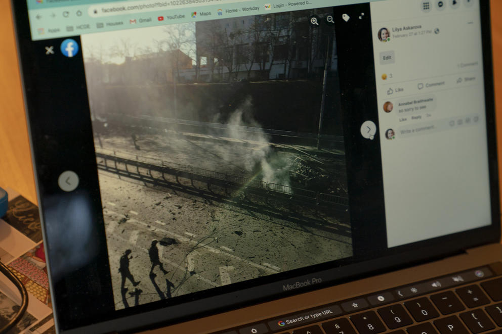 A damaged road in Kyiv is seen in a Facebook photo as it is displayed on a computer