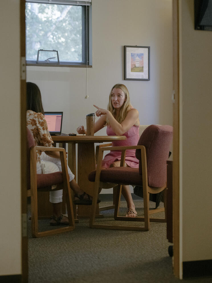 Women seated talking in office