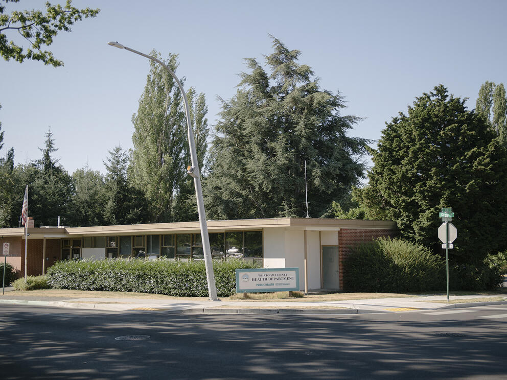 A one-story building backed by trees