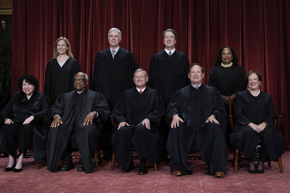 A group of nine people in black robes