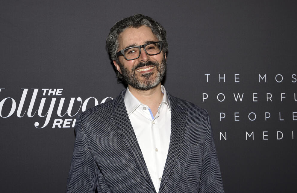 Smiling bearded man with glasses
