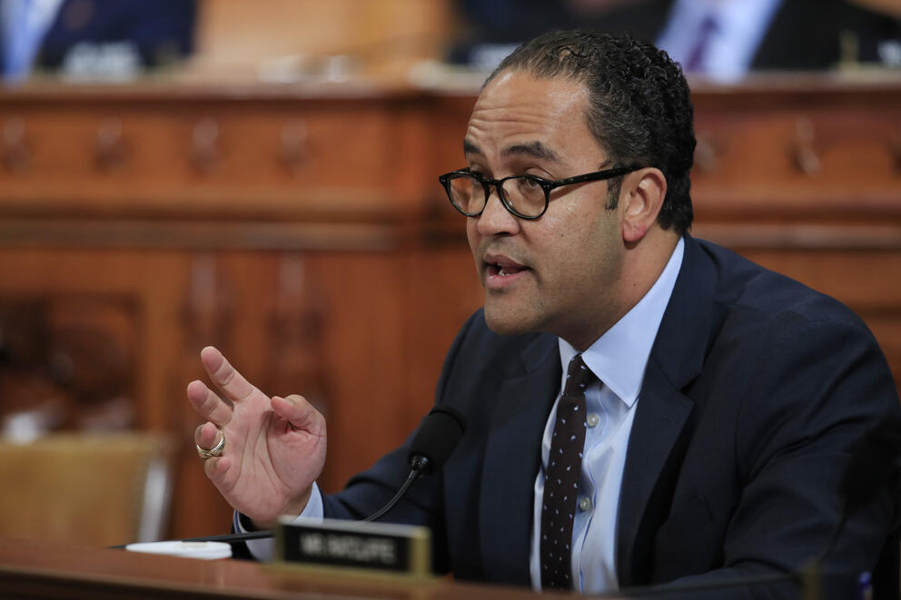 A congressperson at a desk speaking