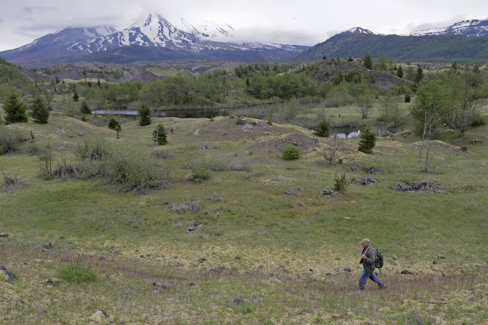 a man walks near a mountain