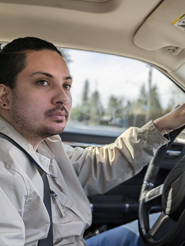 A person behind the wheel of a car.