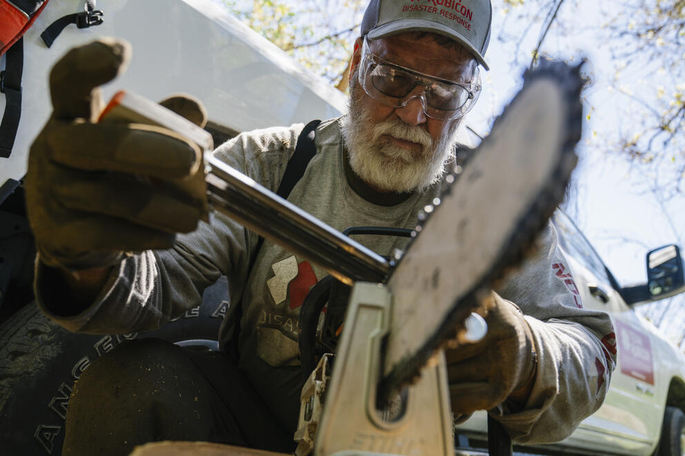 Jeff Sesak sharpens a chainsaw 