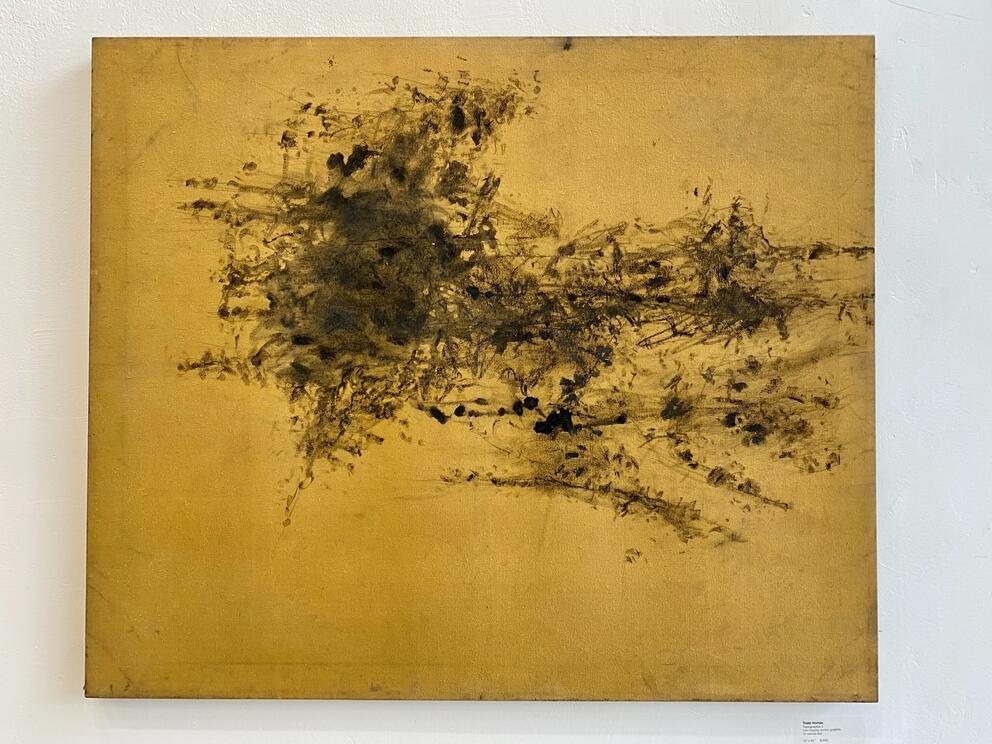abstract drawing of black markings on golden canvas