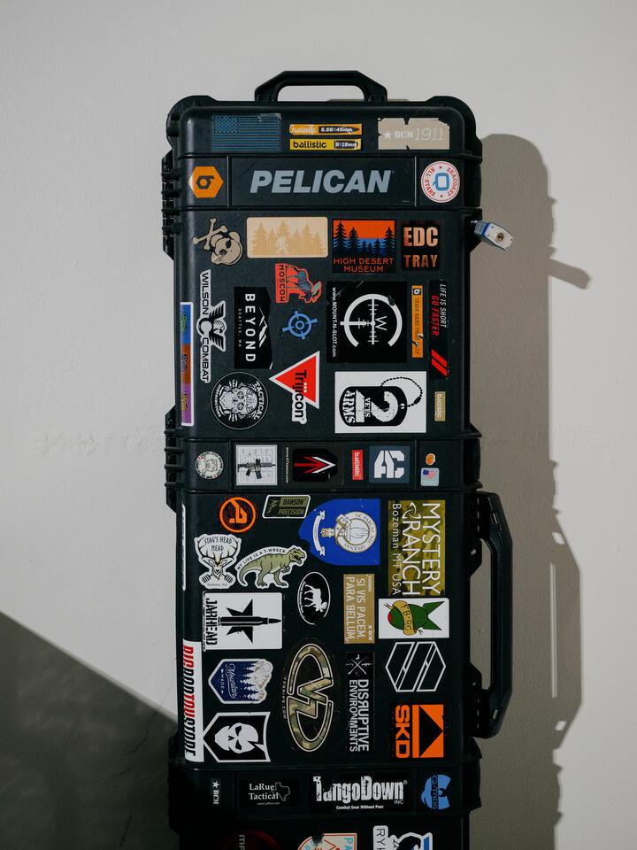 A locked Pelican gun case rests against a wall.