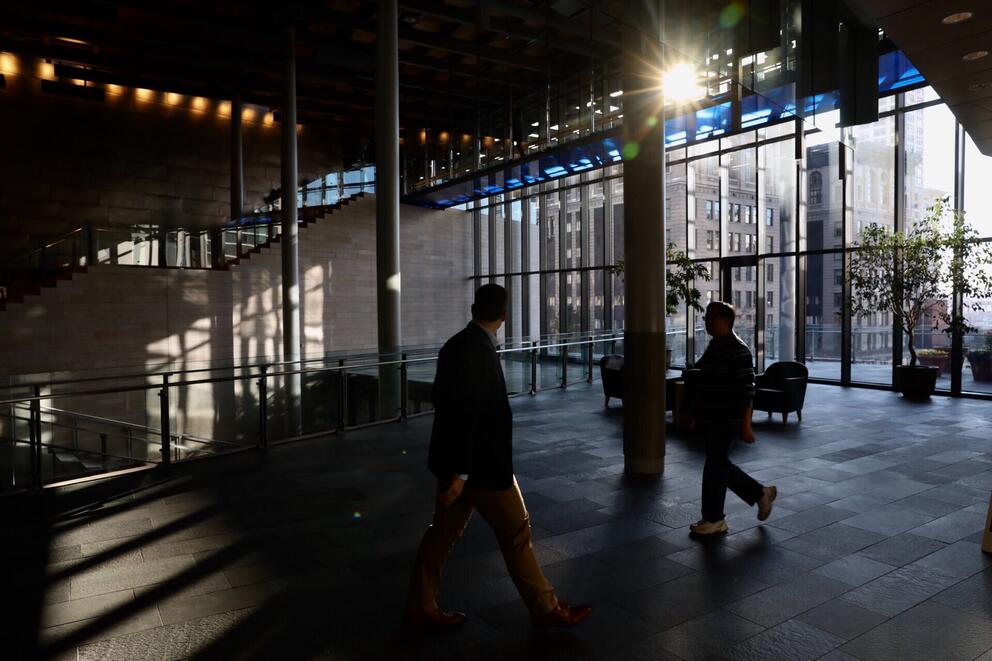 people walking through the city hall lobby