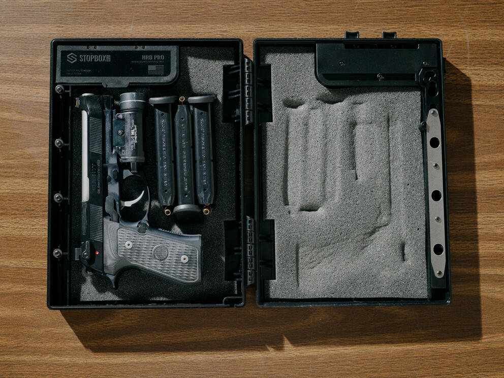 a gun sits inside a safety lock box