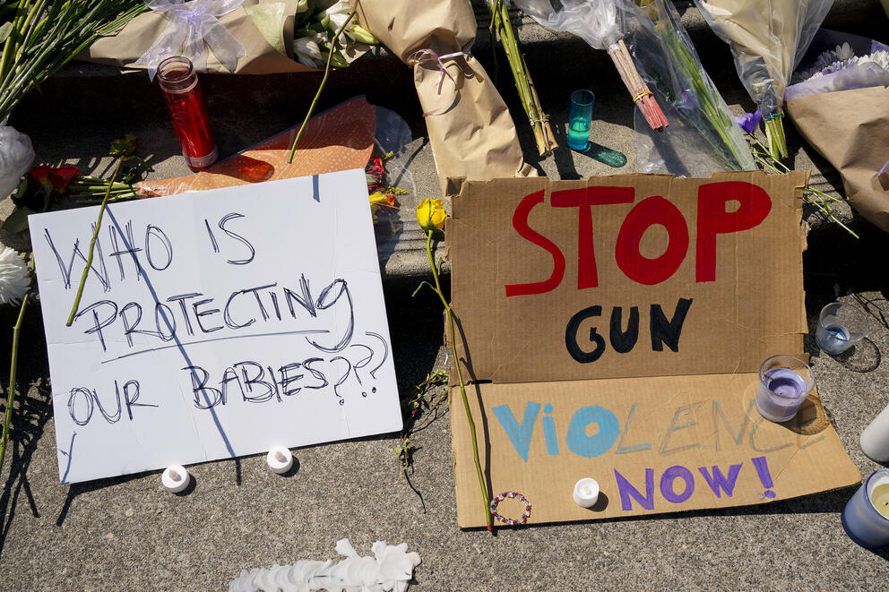 signs at a memorial for a student killed