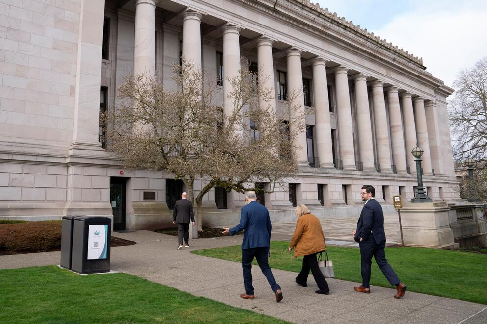 Jay Inslee, his wife Trudy and press secretary Mike Faul walk toward the Washington State Capitol