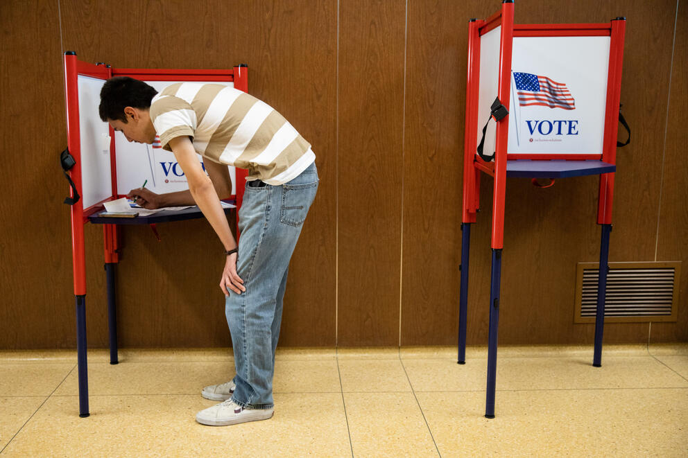 Latino voter filling out ballot 