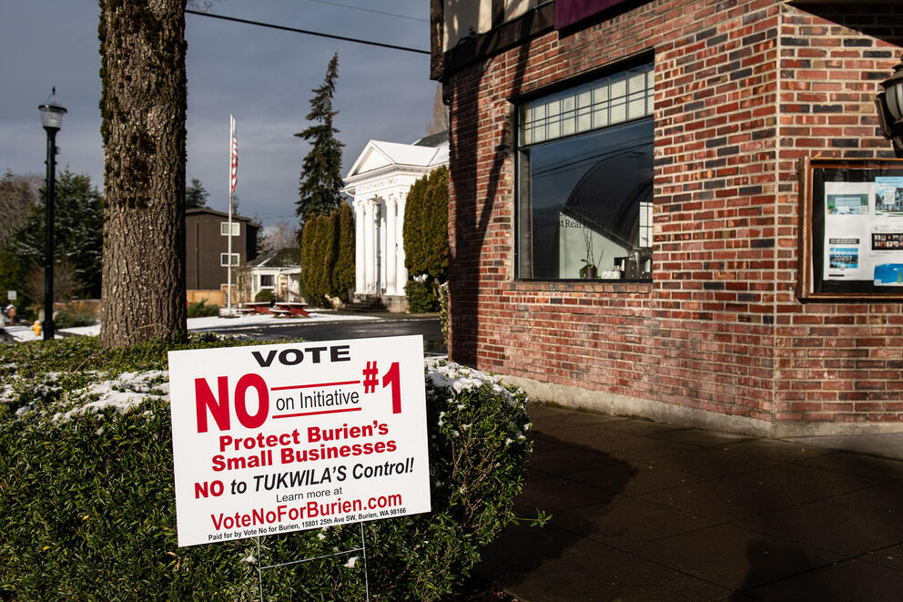 A building with a campaign sign out front.