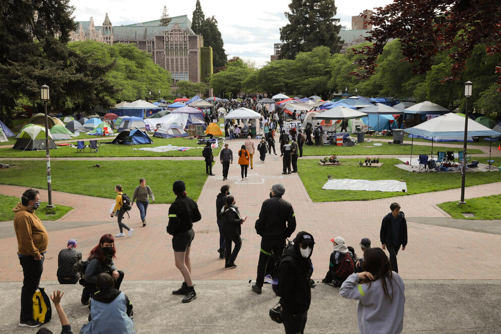 Tents set up in the outdoor common area of a college campus.