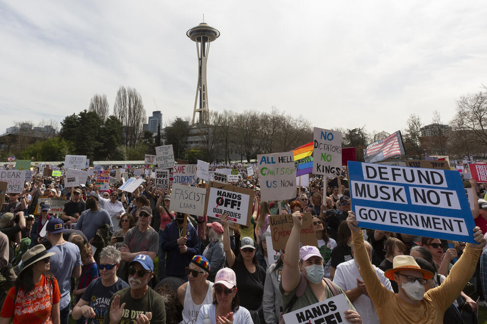 A crowd of protestors with the Space Needle in the background