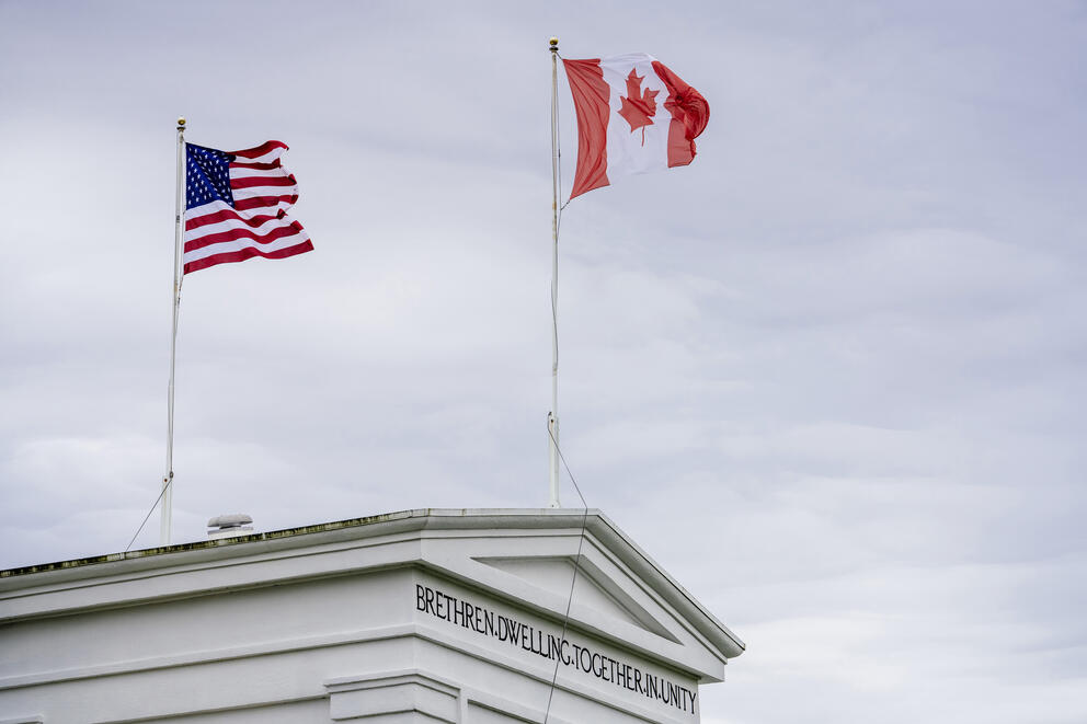 The American and Canadian flags fly above the Peace Arch at the US-Canada Border in Blaine, Washington.