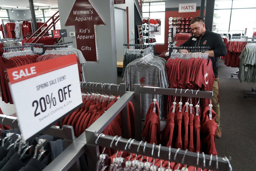 clothes racks showing sports apparel items marked down 20% on sale