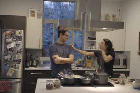 woman putting hand on mans shoulder and smiling